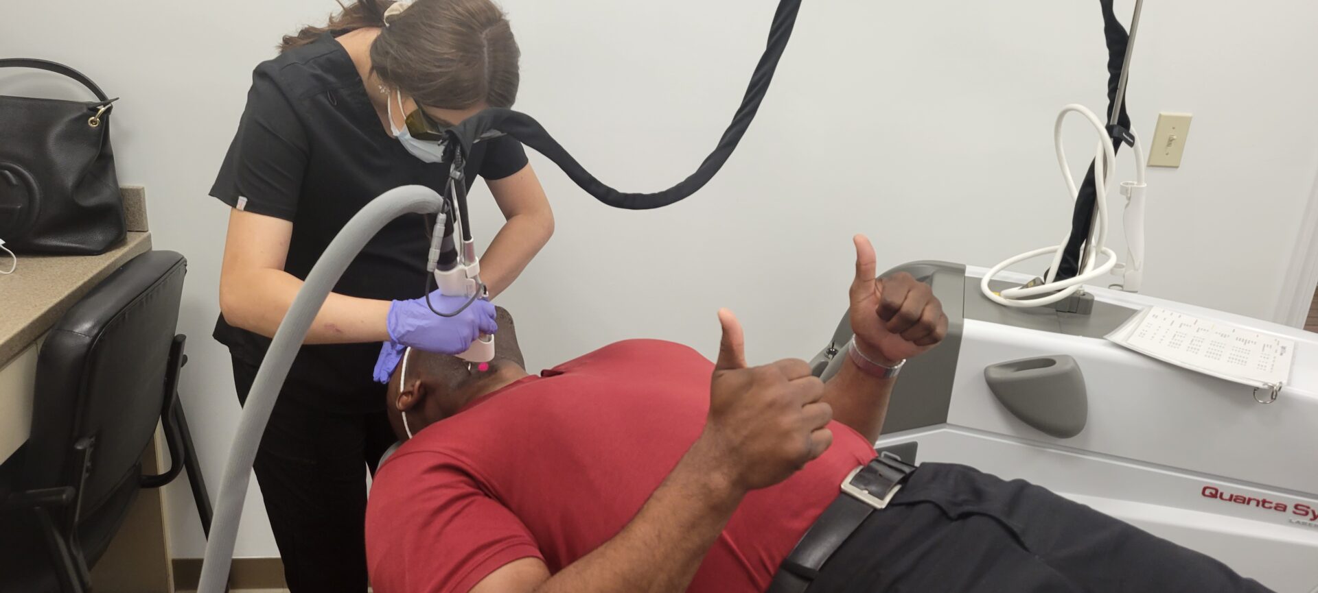 A man getting his teeth checked by an esthetician.