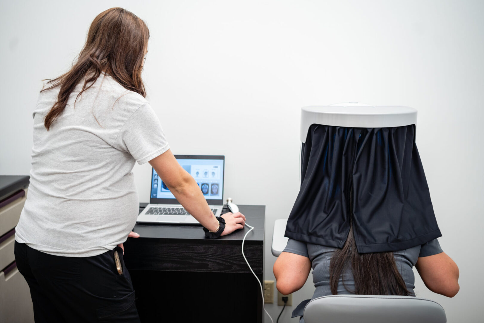 A person sitting at a desk with a laptop