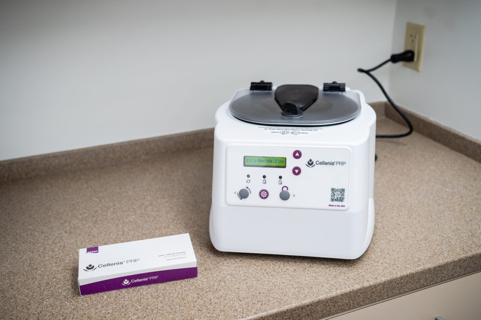 A white machine sitting on top of a counter.